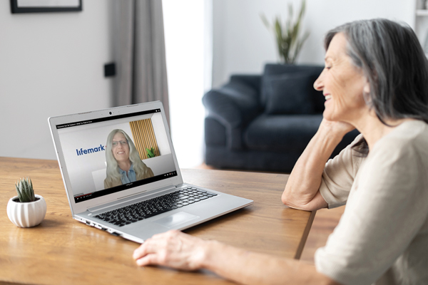 a woman watching a webinar on her laptop at home
