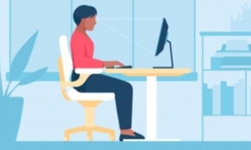 women sitting at her desk in an ergonomic station