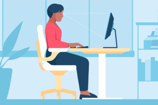 women sitting at her desk in an ergonomic station