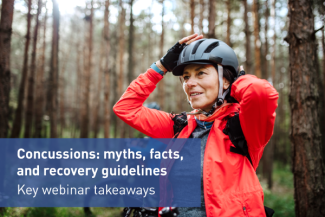 Woman adjusting helmet on a trail 